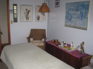 Peaceful and serene massage therapy room with soft lighting and healing atmosphere, designed for relaxation and spiritual wellness