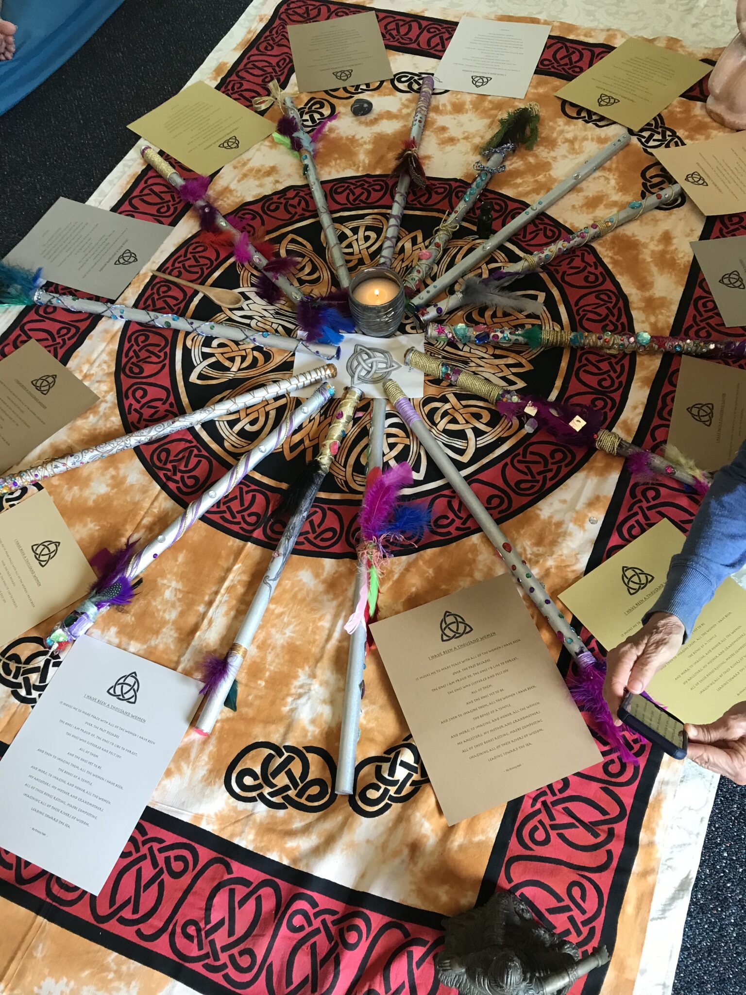 Person receiving a psychic reading with tarot cards spread on a table in a peaceful spiritual setting